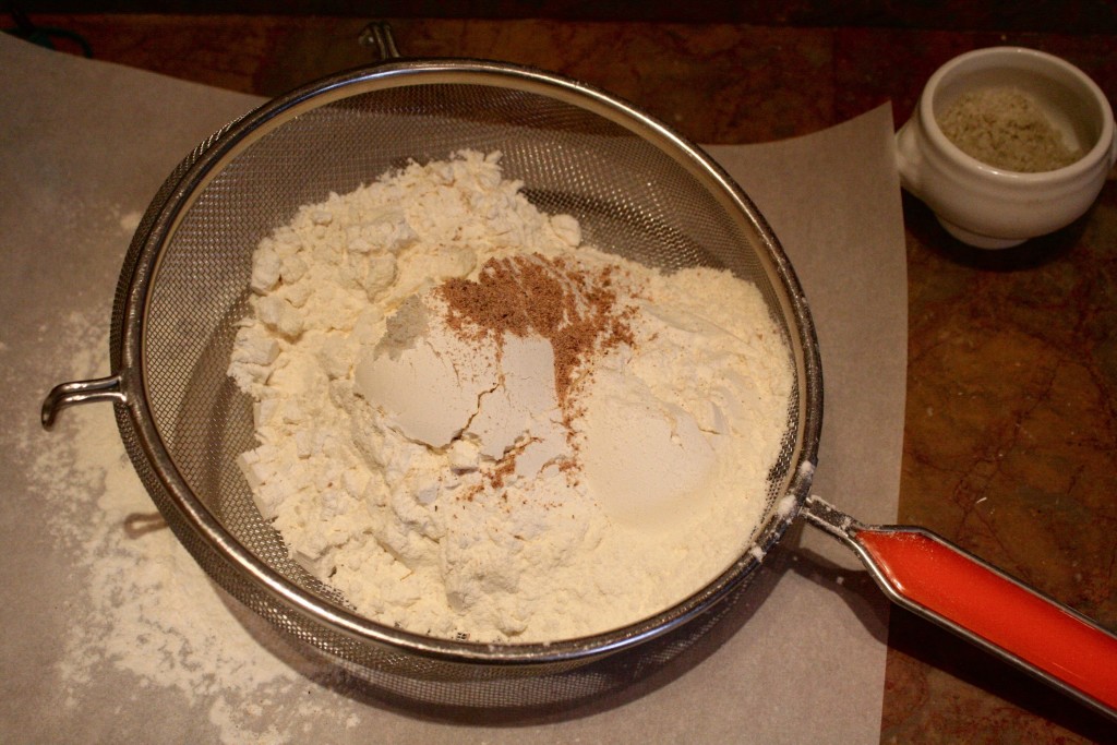   Sift the flour, salt, and nutmeg together onto a piece of parchment paper.