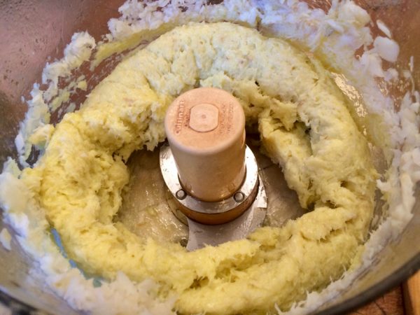 Place the salt cod and the garlic in the bowl of a food processor. With the machine running, add the hot oil in a thin stream. Pulse on and off, so the cod isn’t over-beaten.  When the oil is incorporated and the mixture is quite smooth, slowly add the milk in a thin stream, pulsing on and off to avoid over mixing the brandade.  It should be light, white, and fluffy, like pudding.