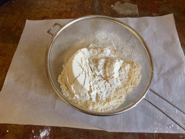 Sift the dry ingredients onto a piece of parchment paper.