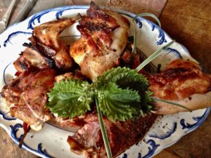 rabbit on the grill, with herbs and bacon