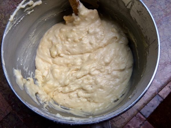 In a large bowl, whisk together the eggs and the sugar until they are light , fluffy, and pale yellow.  Sprinkle the dry ingredients over the eggs and sugar, whisking to incorporate them as you do.  Fold in the yogurt and vanilla, then the melted butter.      